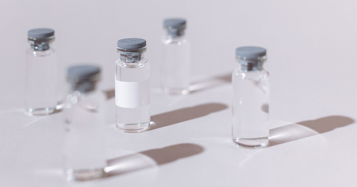 Multiple glass peptide research vials with stoppers arranged on a clean background for BPC-157 and TB-500 studies